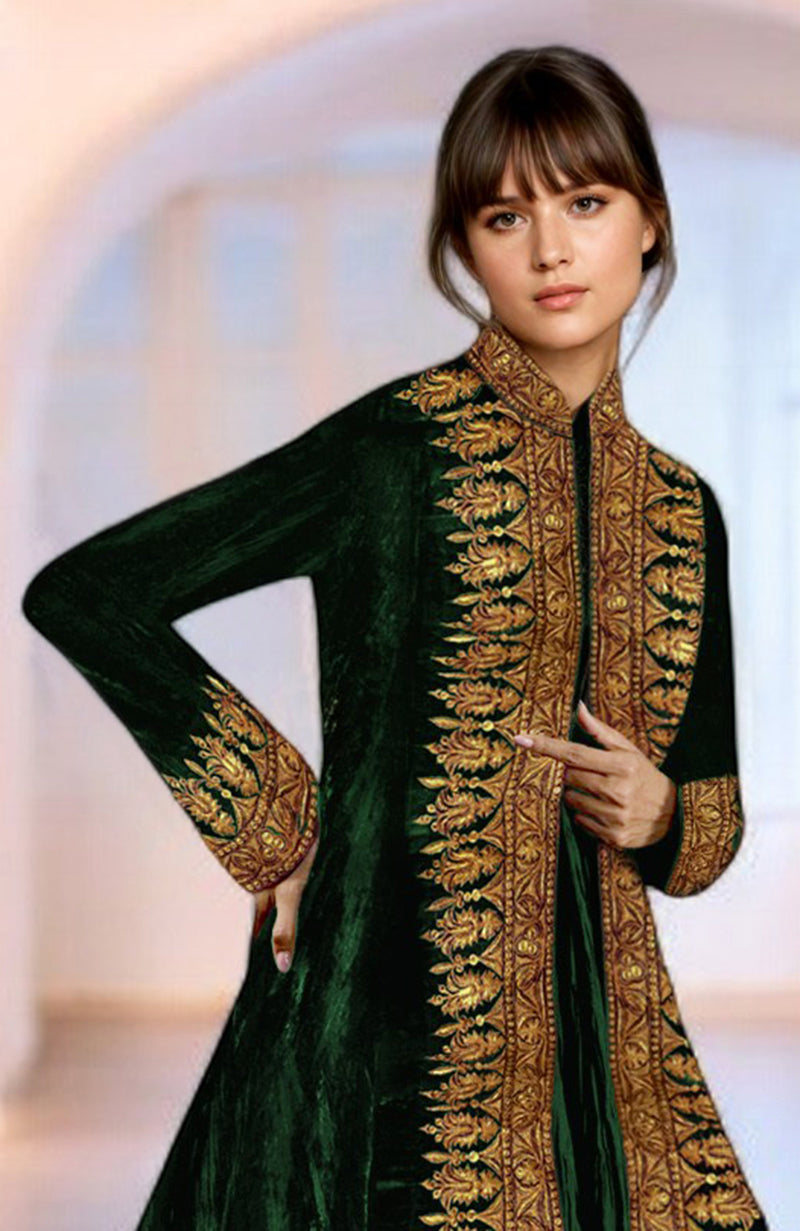 A woman models an emerald green velvet jacket with gold Kashmiri Tilla embroidery.