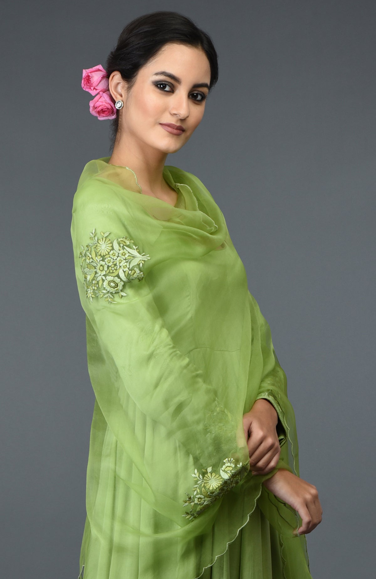 A woman models a pista green floral embroidered anarkali suit with dupatta.