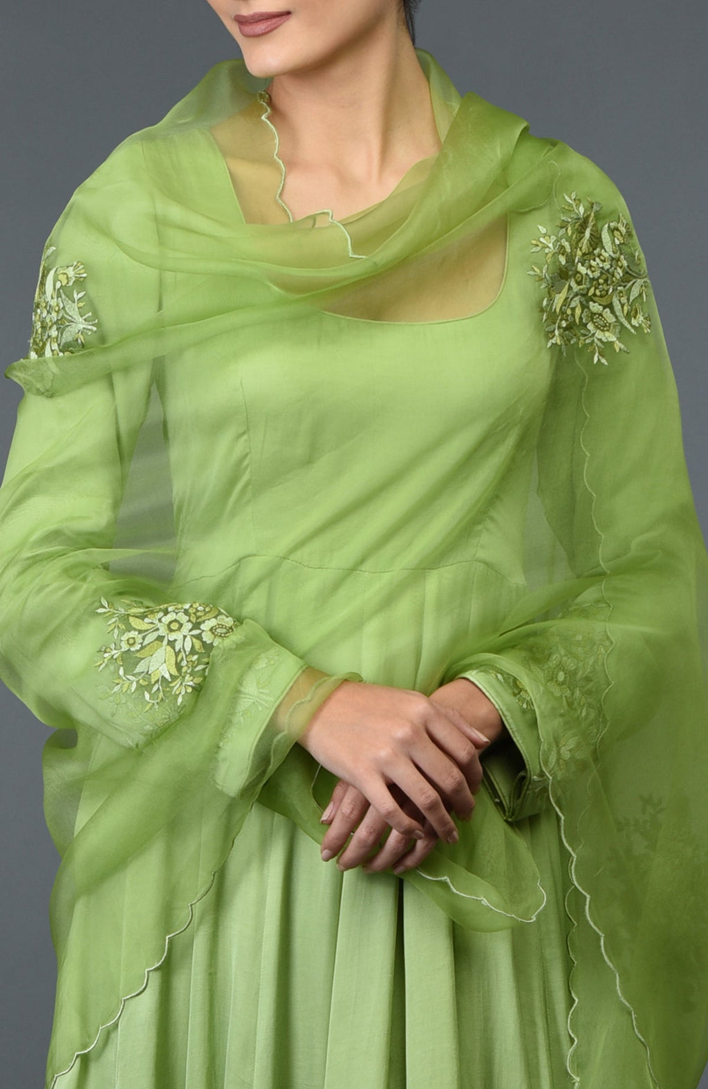 Pista green anarkali suit with floral embroidery on sleeves and dupatta.