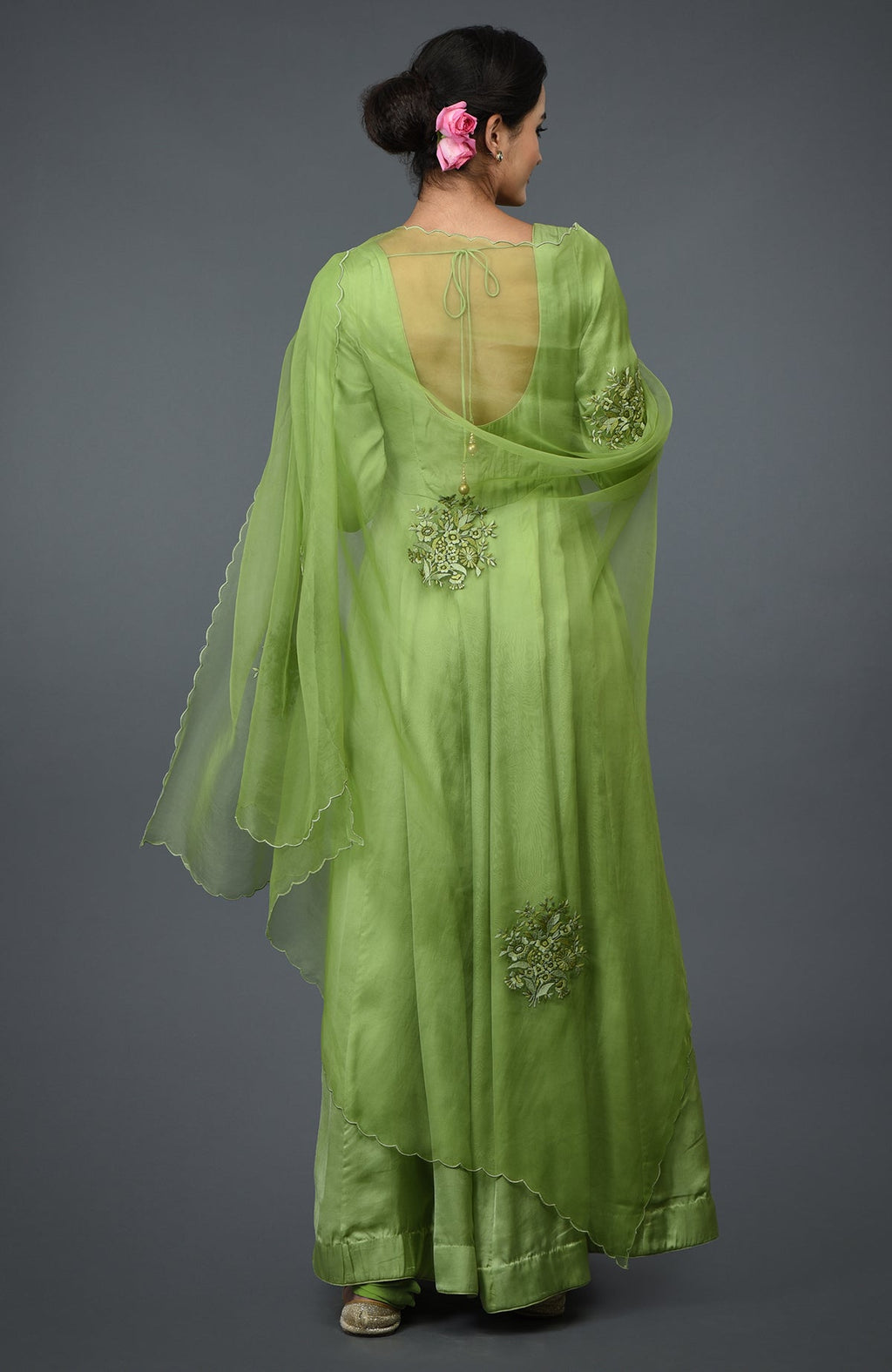 Pista green floral embroidered anarkali suit with dupatta, viewed from the back.