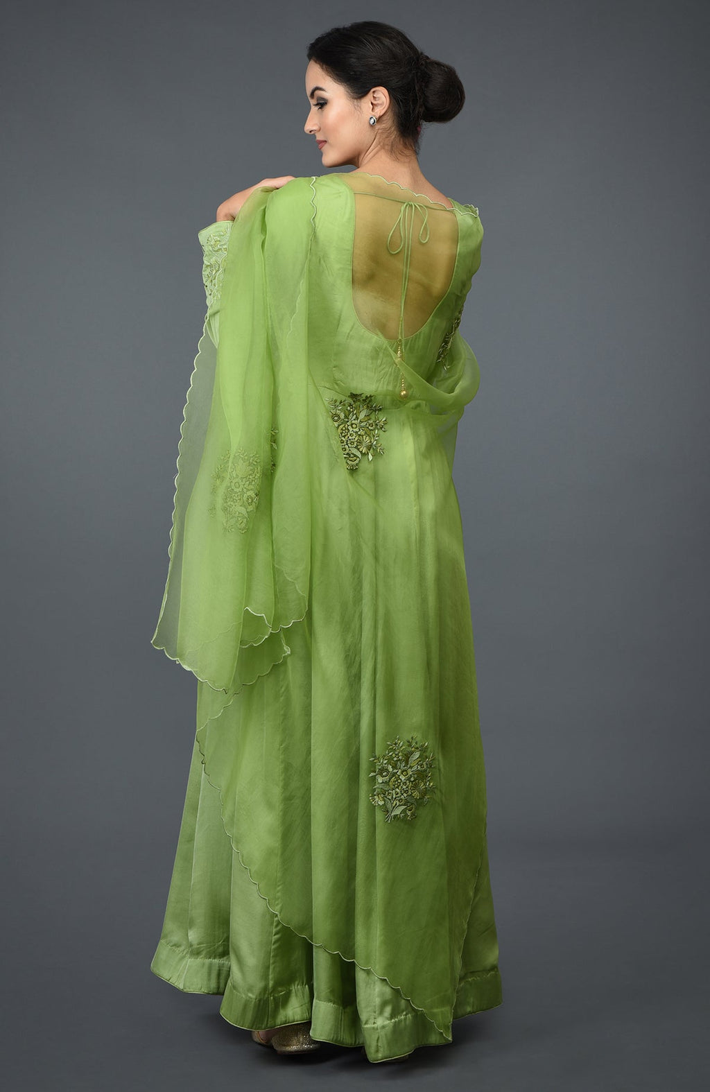 Pista green floral embroidered anarkali suit with dupatta, viewed from the back.