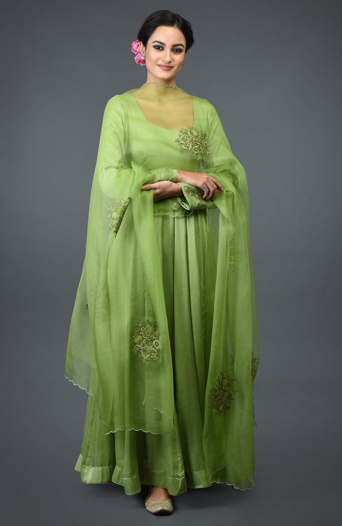 Pista green floral embroidered Anarkali suit with dupatta, worn by a woman.