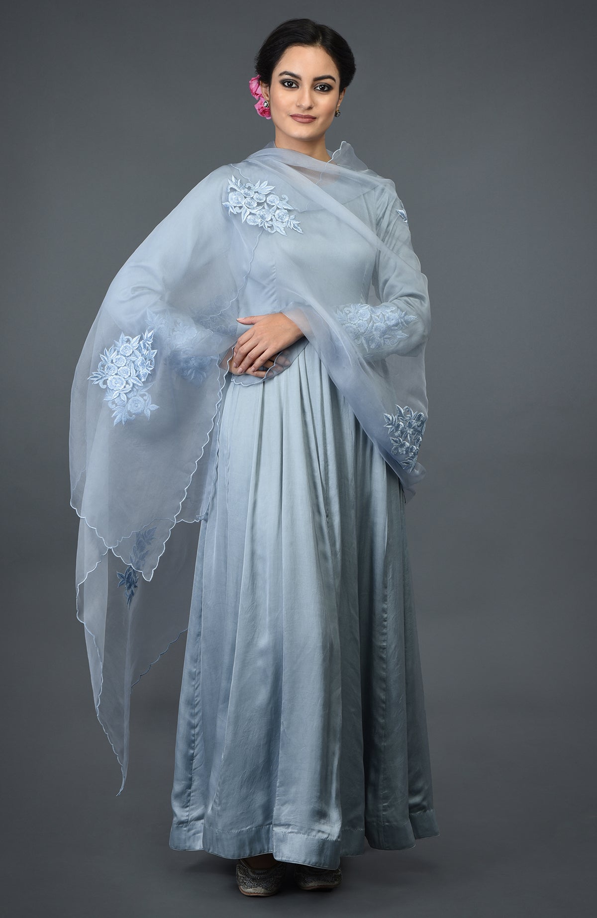 A woman models a powder blue floral embroidered anarkali suit with a matching dupatta.