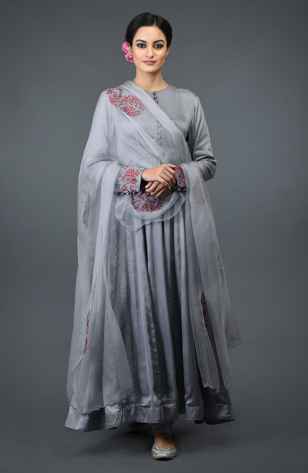 A woman models a grey paisley embroidered Anarkali suit with a matching dupatta.