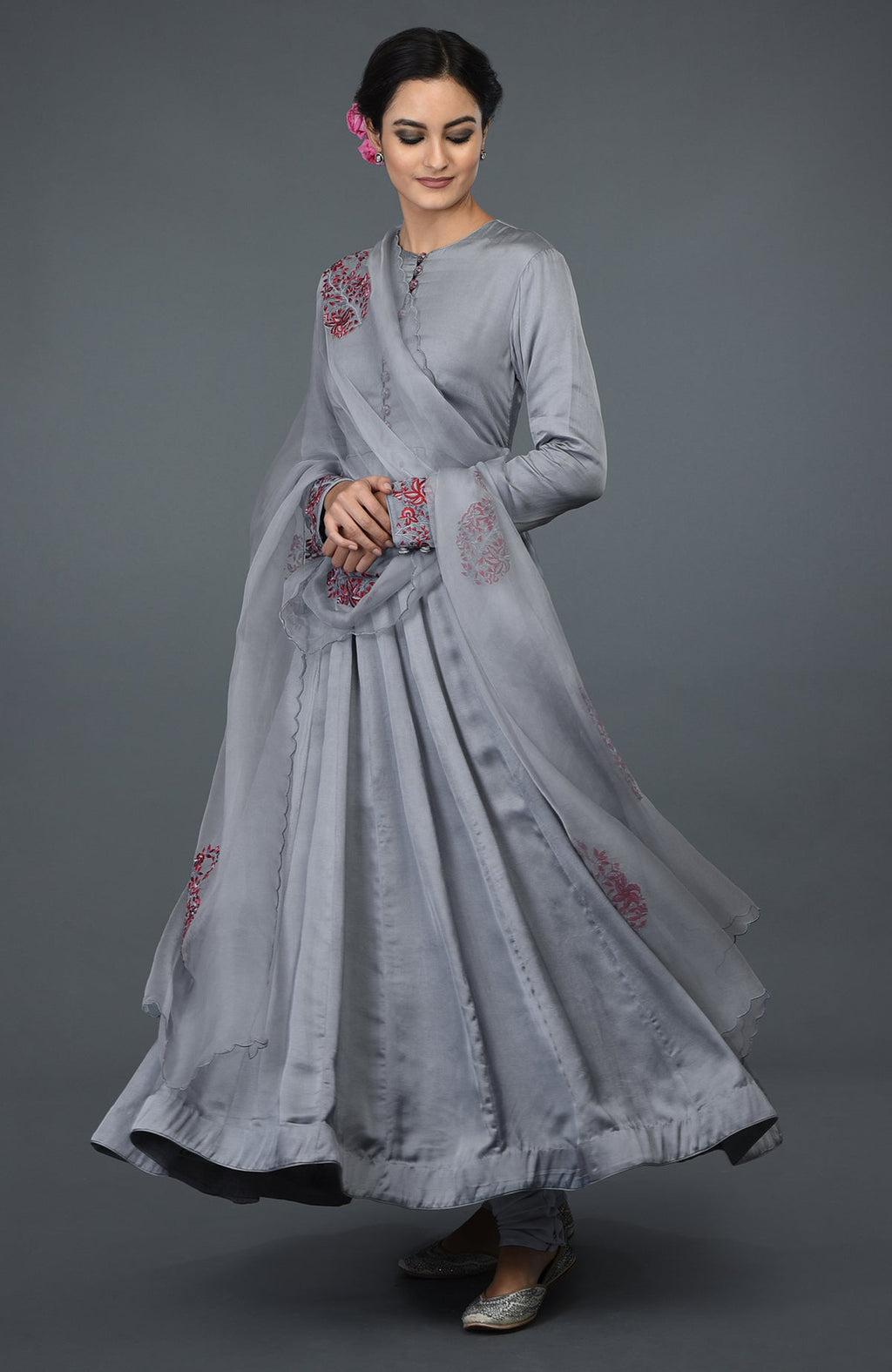 A woman models a grey paisley embroidered Anarkali suit with a matching dupatta.