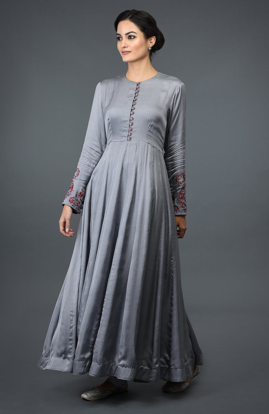 A woman models a grey paisley embroidered Anarkali suit with a dupatta.