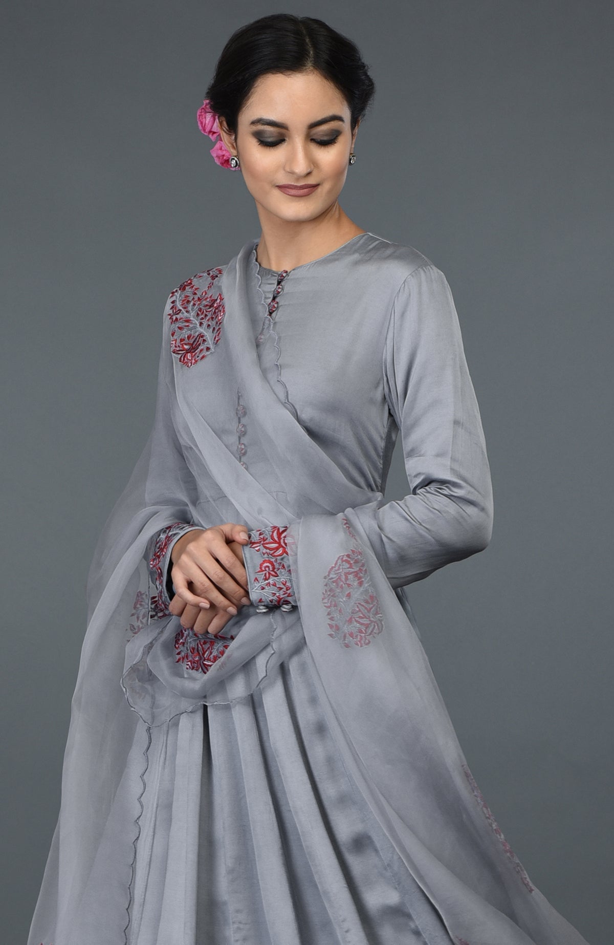 Grey paisley embroidered Anarkali suit with dupatta, worn by a woman.