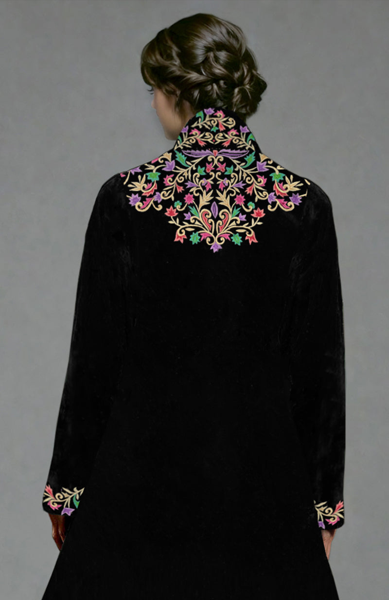 Black velvet jacket with colorful floral Parsi Gara embroidery and matching crushed silk tiered skirt.