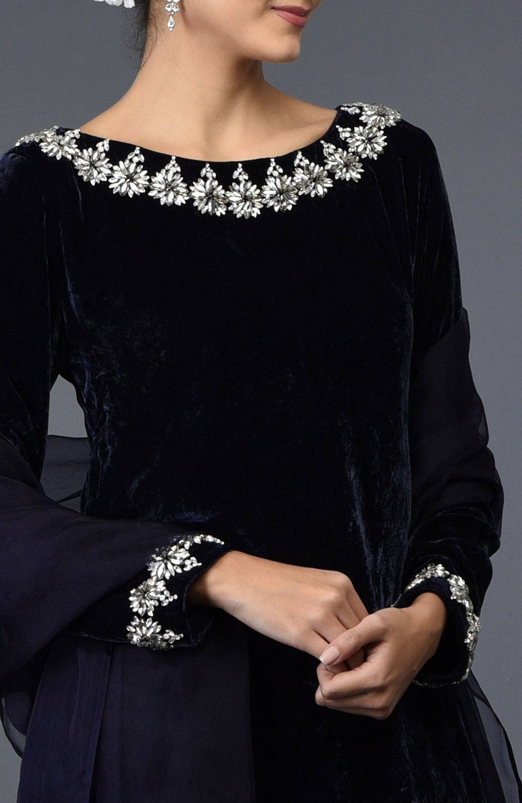 A woman models a midnight blue velvet suit with Swarovski crystal embroidery.
