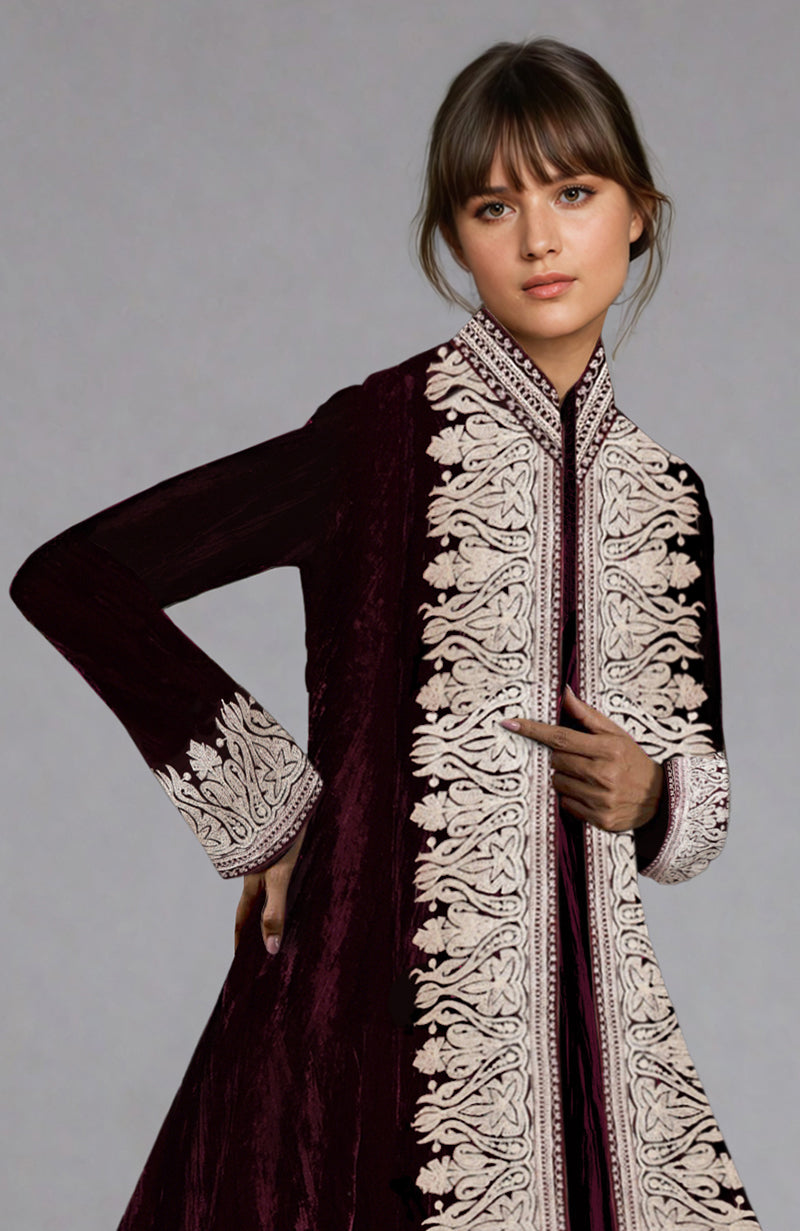 A woman models a maroon velvet jacket with silver Kashmiri Tilla Aari embroidery.