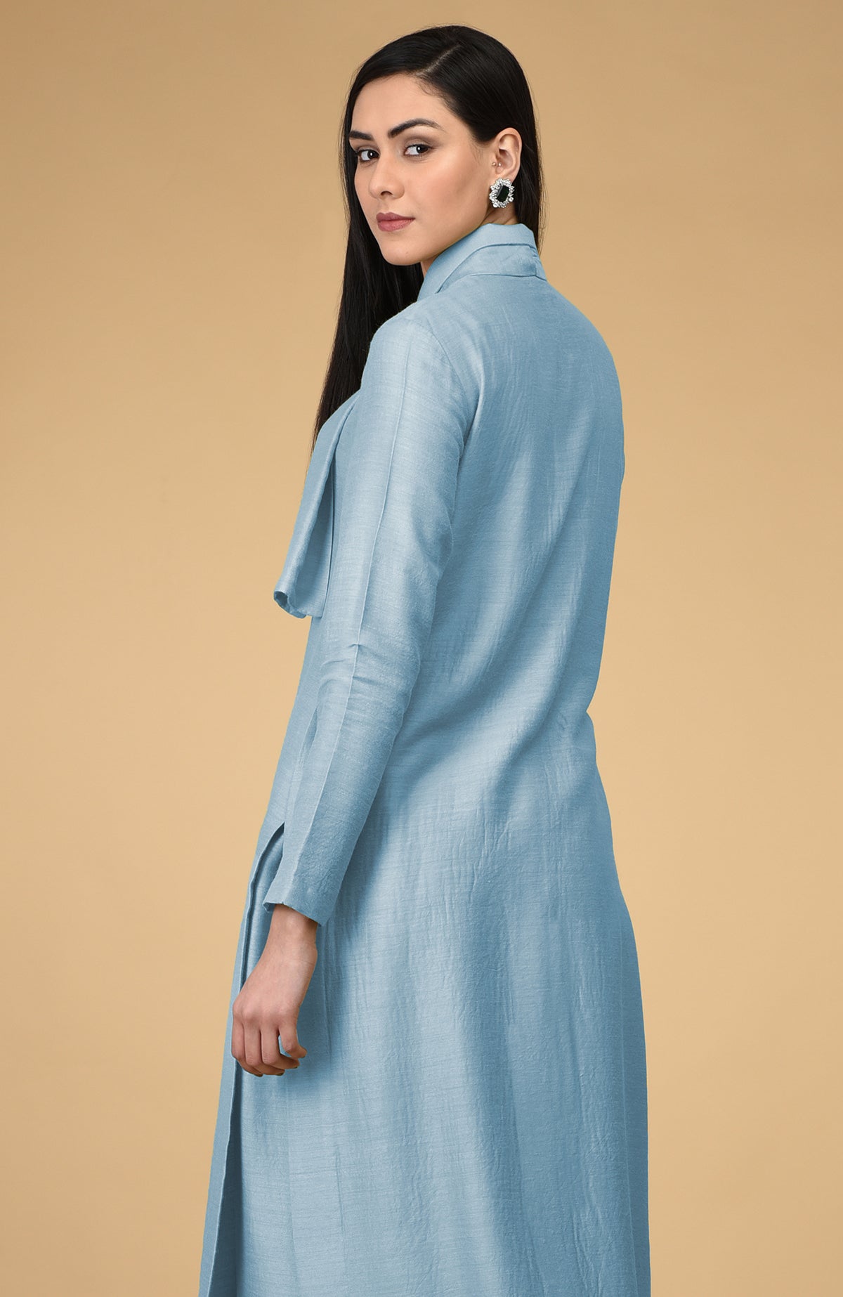 Woman in a light blue tie-neck kurta with long sleeves.