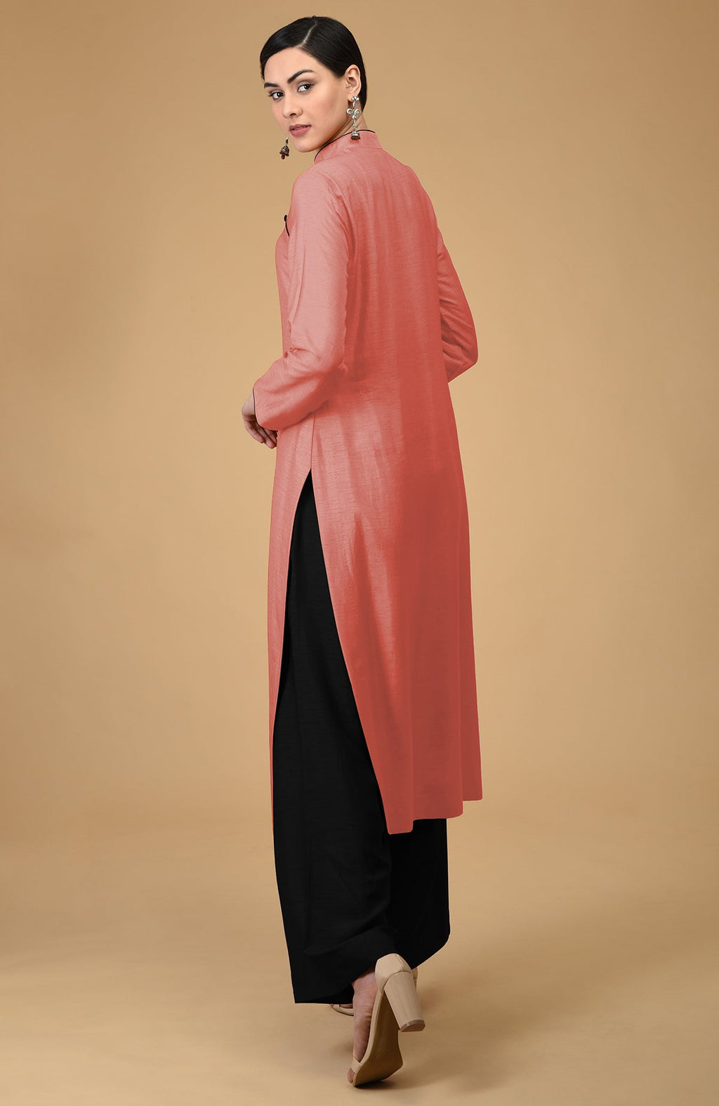 Woman in terracotta mandarin collared kurta with black wide-leg pants.