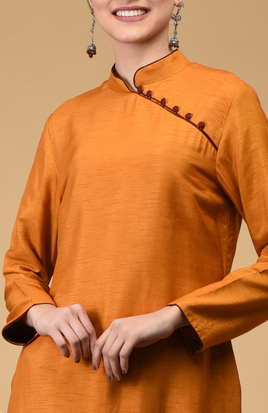 Mustard dupion silk kurta with mandarin collar and maroon button closures.
