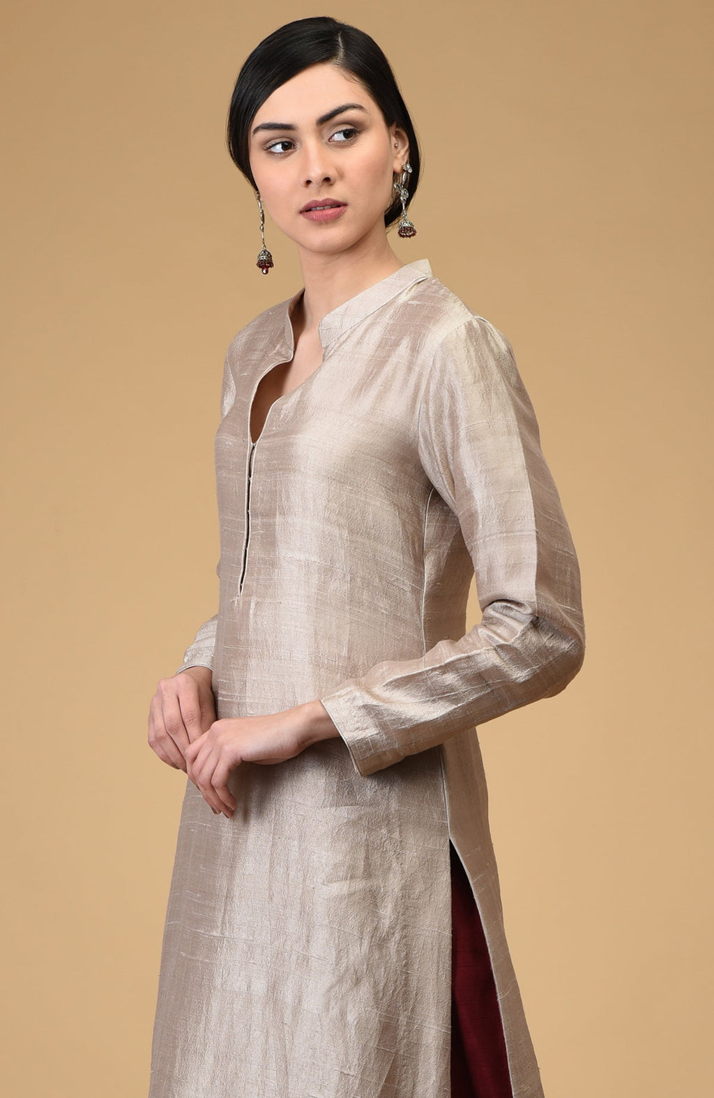 Beige raw silk kurta with a mandarin collar and maroon wide-leg pants.
