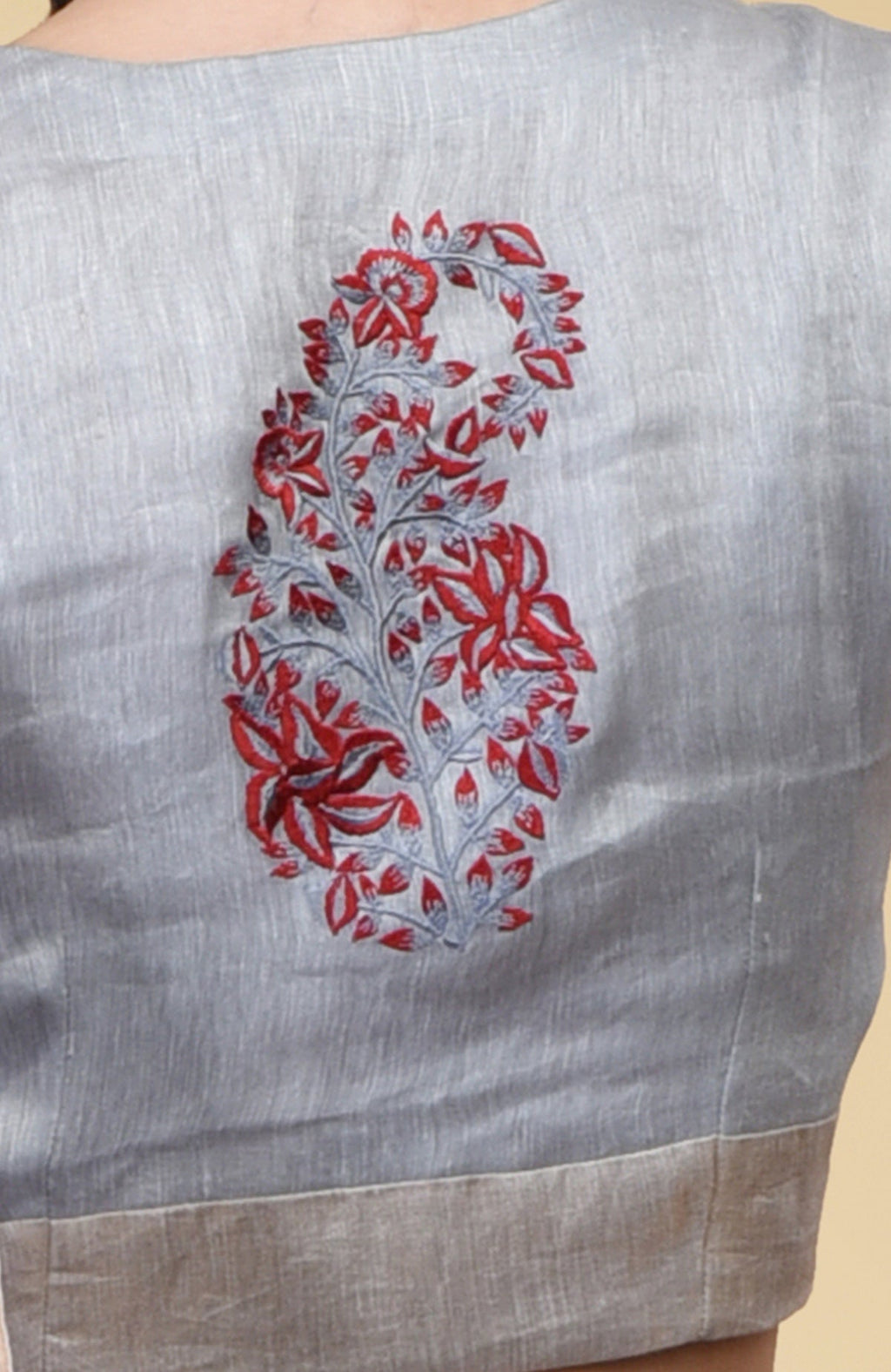 Dove grey linen blouse with a red and grey paisley embroidery on the back.