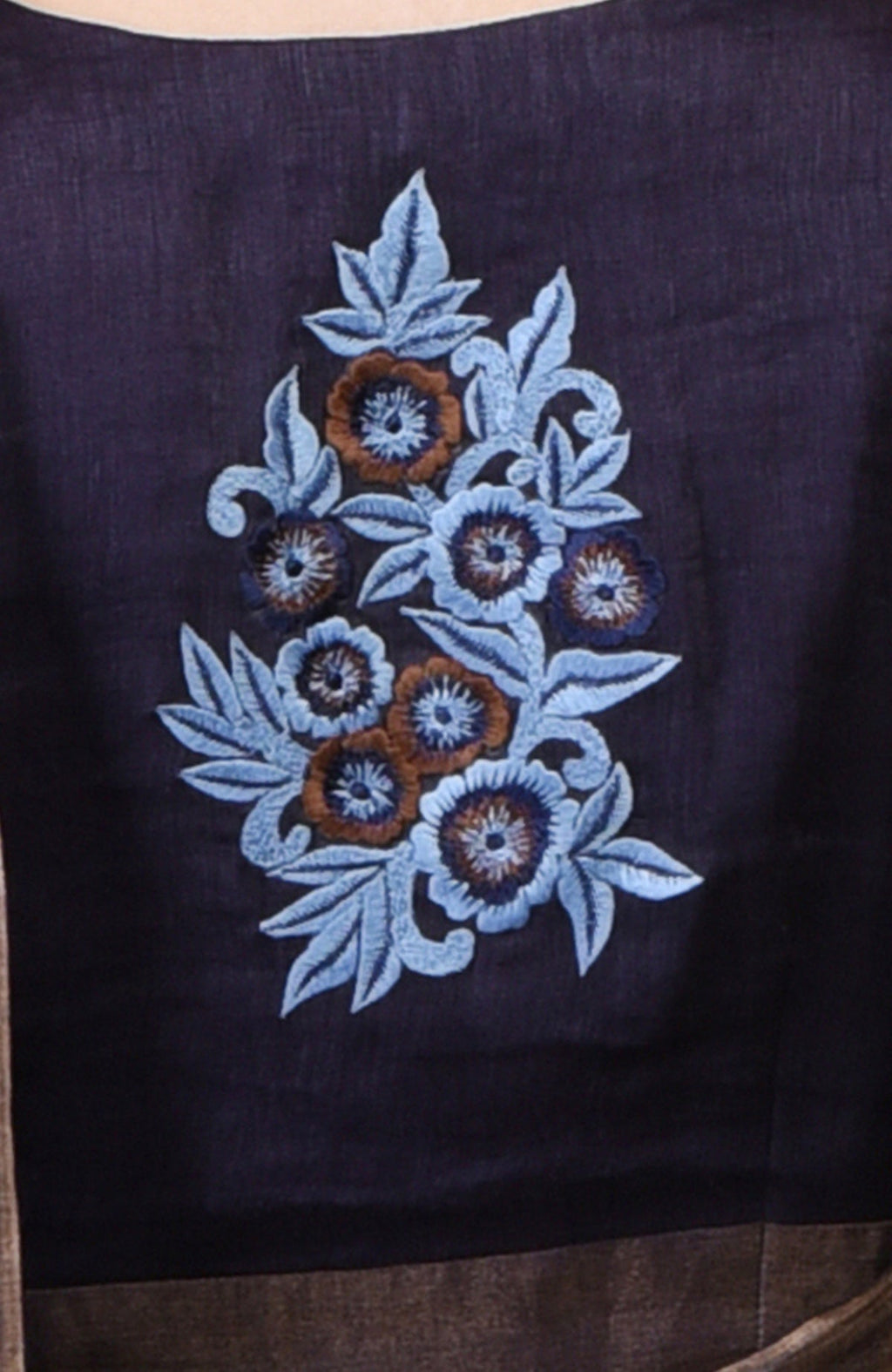 Eclipse blue linen saree with embroidered floral motifs and gold zari weave borders.