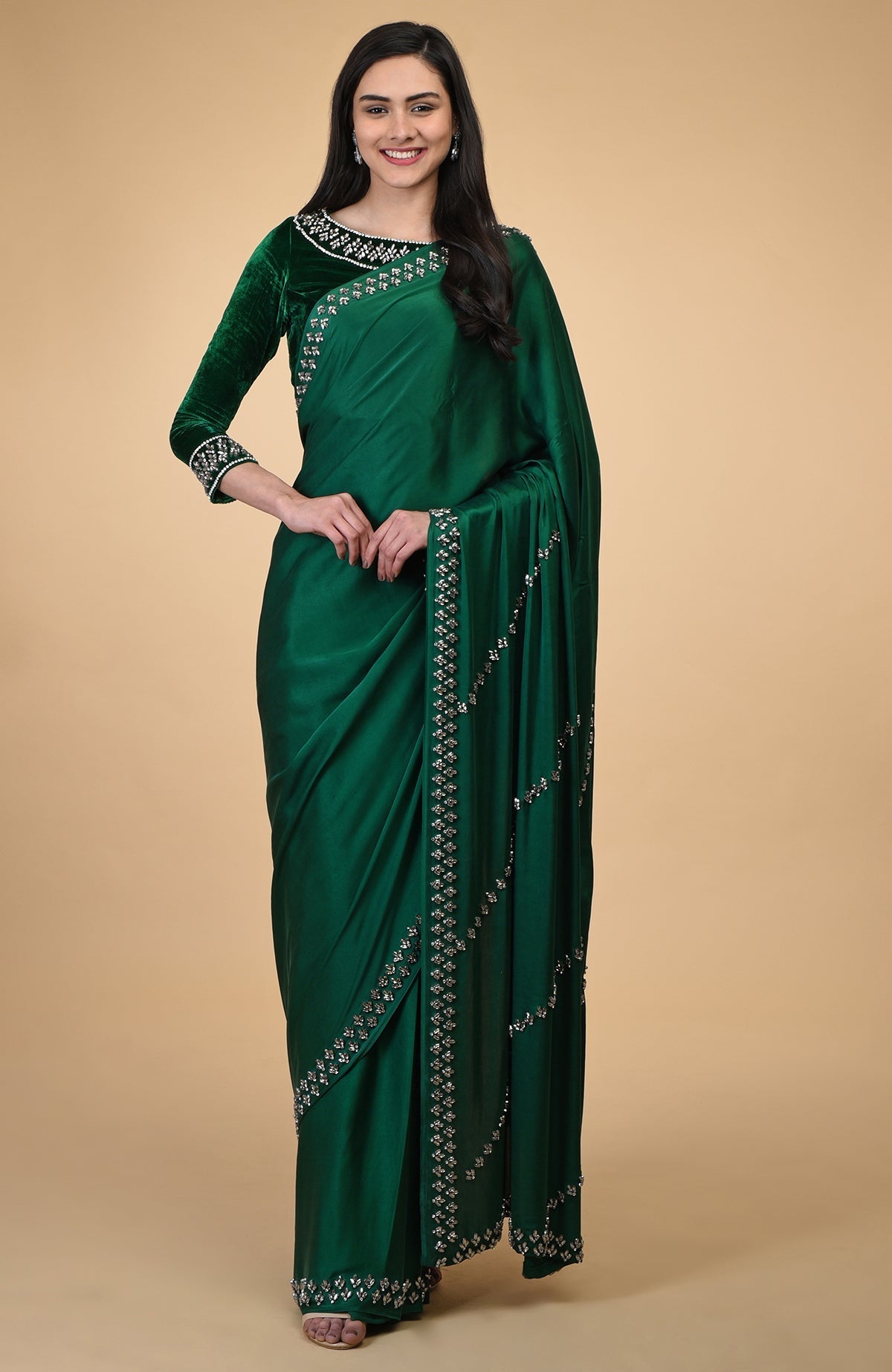 Emerald green crystal hand-embroidered blouse with a matching saree.