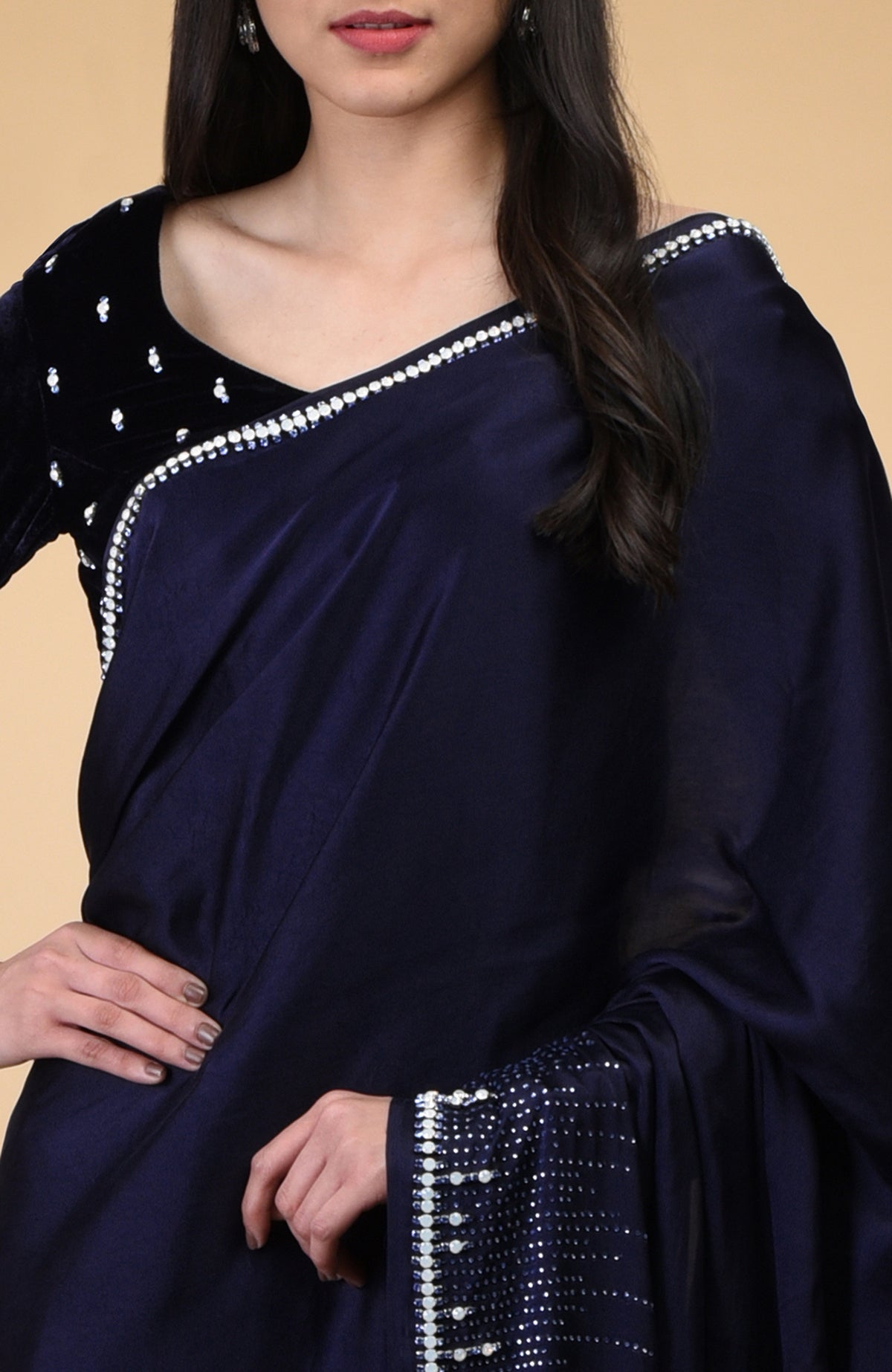 A woman models a midnight blue crystal hand-embroidered blouse and matching saree.