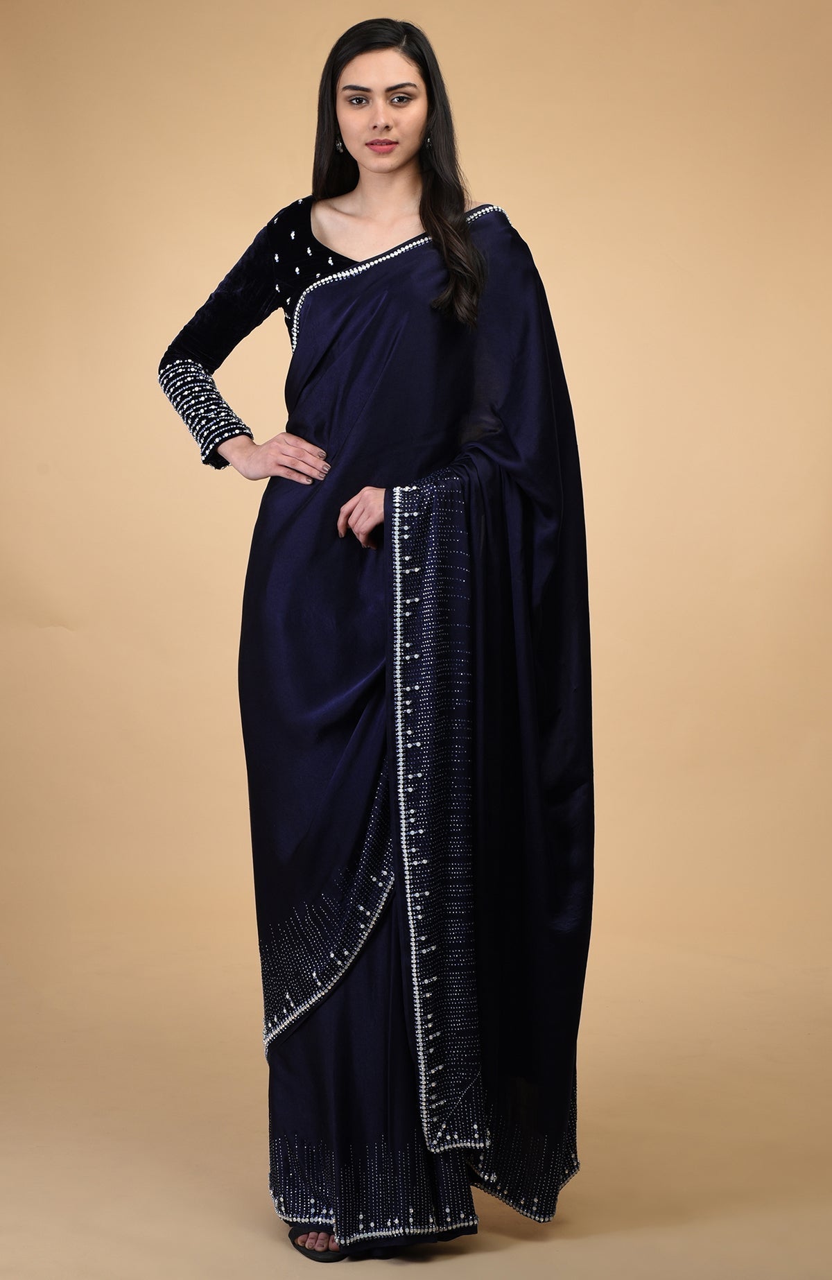 A woman models a midnight blue crystal hand-embroidered blouse and matching saree.