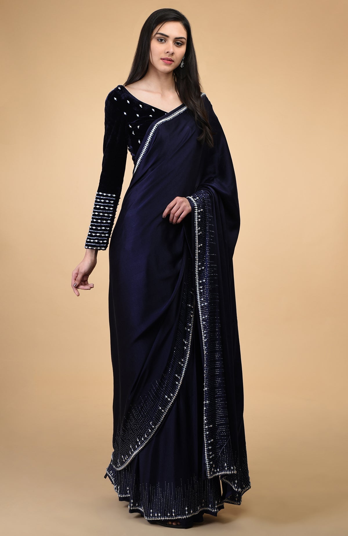 A woman models a midnight blue crystal hand-embroidered blouse and matching saree.