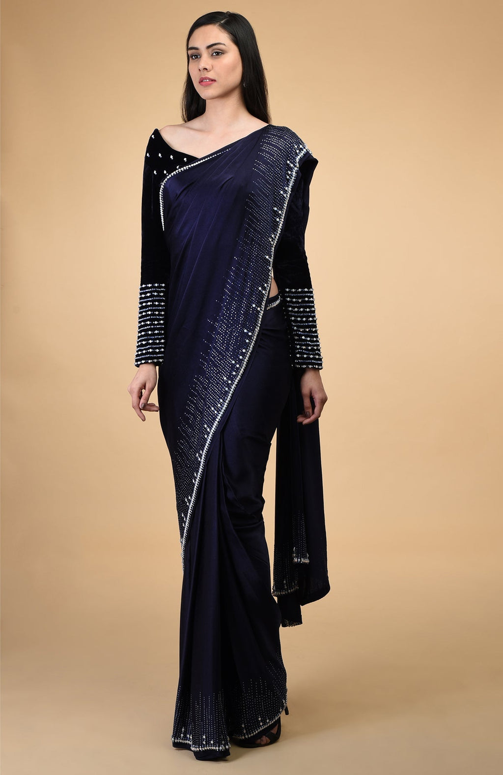 A woman models a midnight blue crystal hand-embroidered blouse and matching saree.