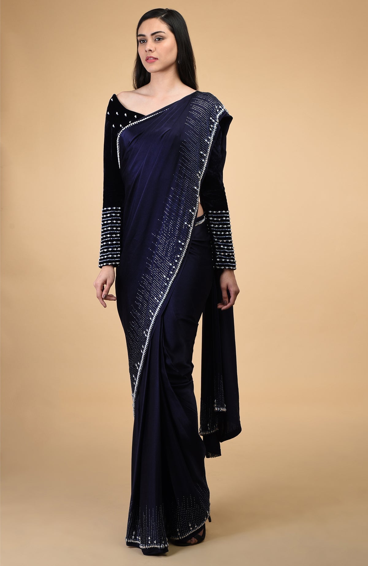 A woman models a midnight blue crystal hand-embroidered blouse and matching saree.
