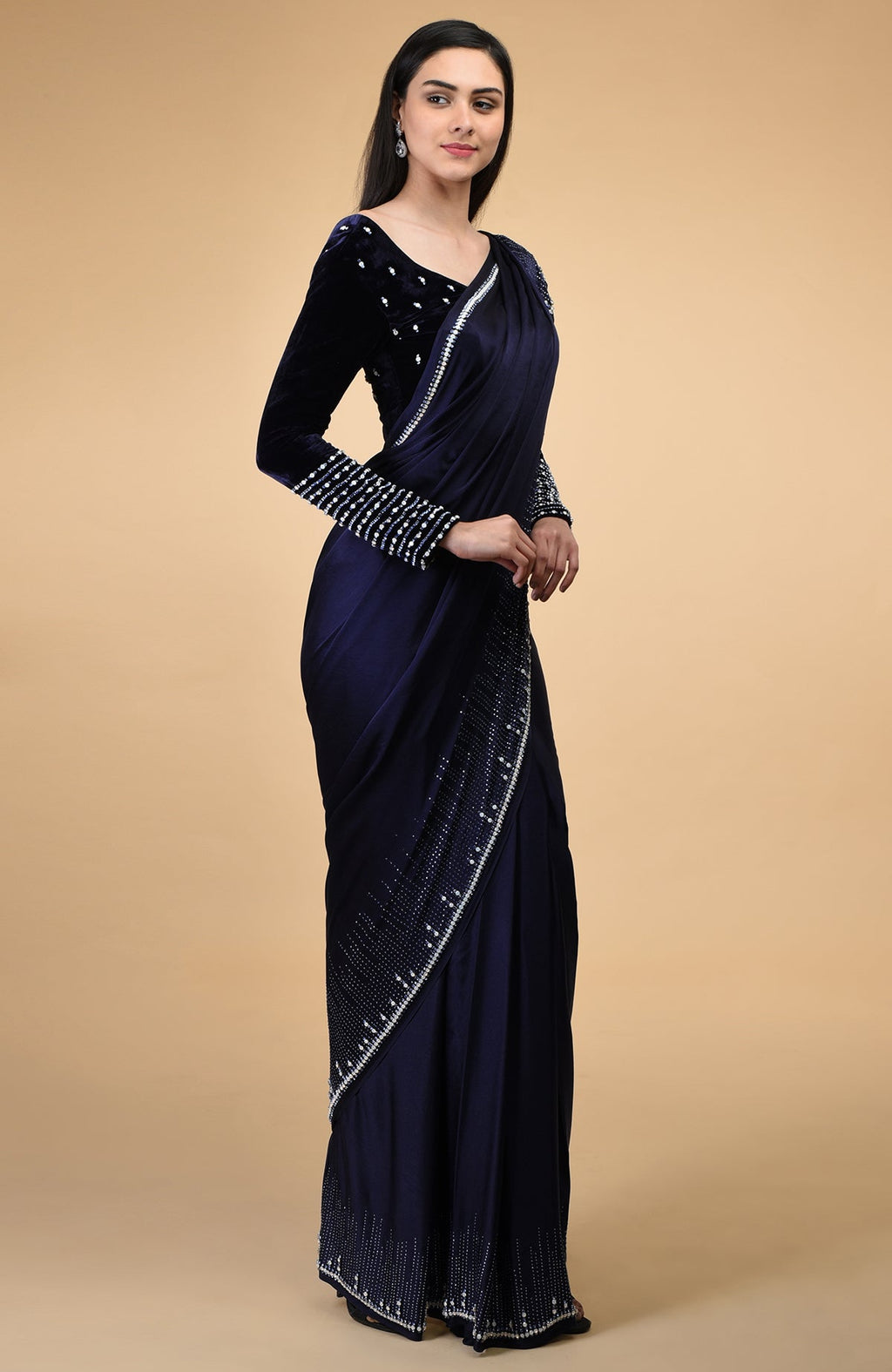 A woman models a midnight blue crystal hand-embroidered blouse and matching saree.