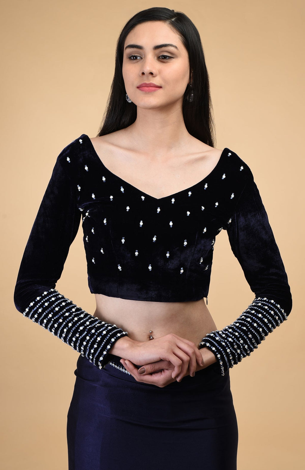 Midnight blue velvet blouse with crystal embroidery and a V-neckline.