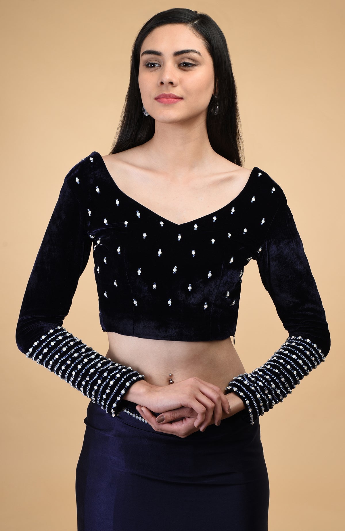 Midnight blue velvet blouse with crystal embroidery and a V-neckline.