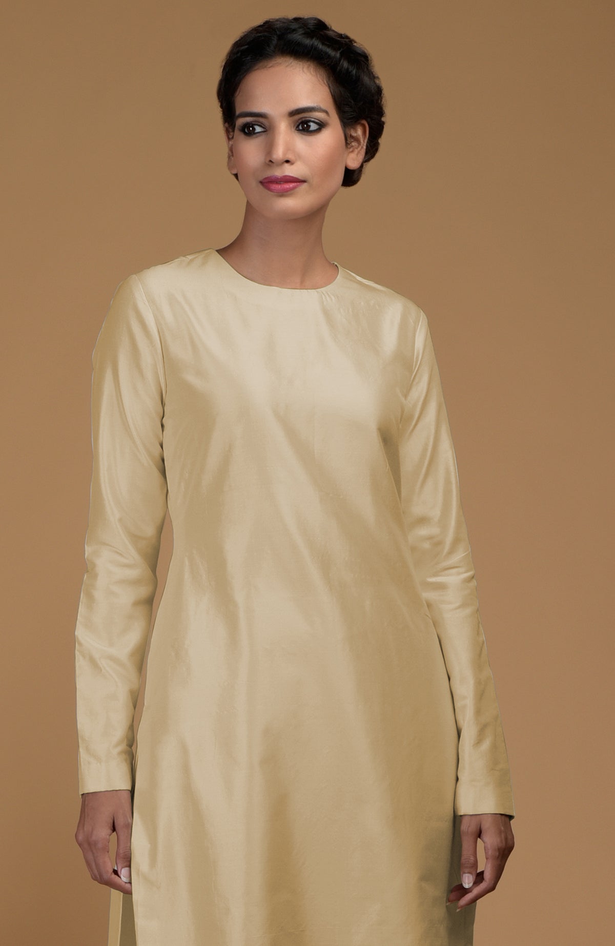 A woman models a beige pure Matka silk jewel neck kurta.