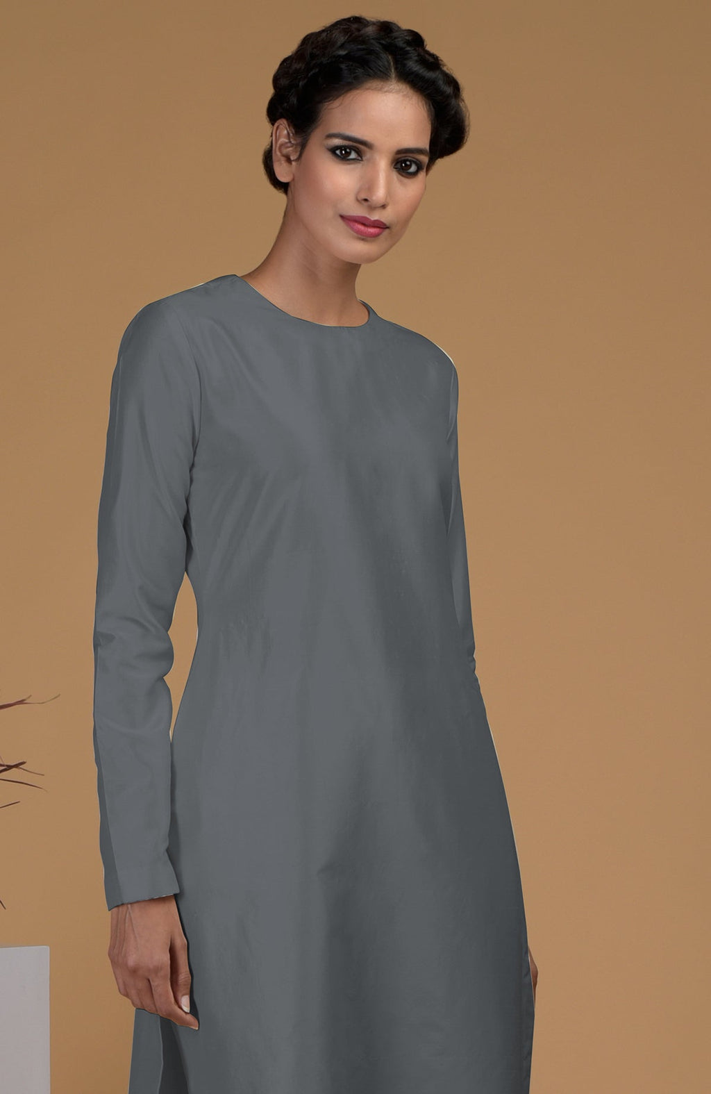 A woman models a grey pure Matka silk jewel neck kurta set.
