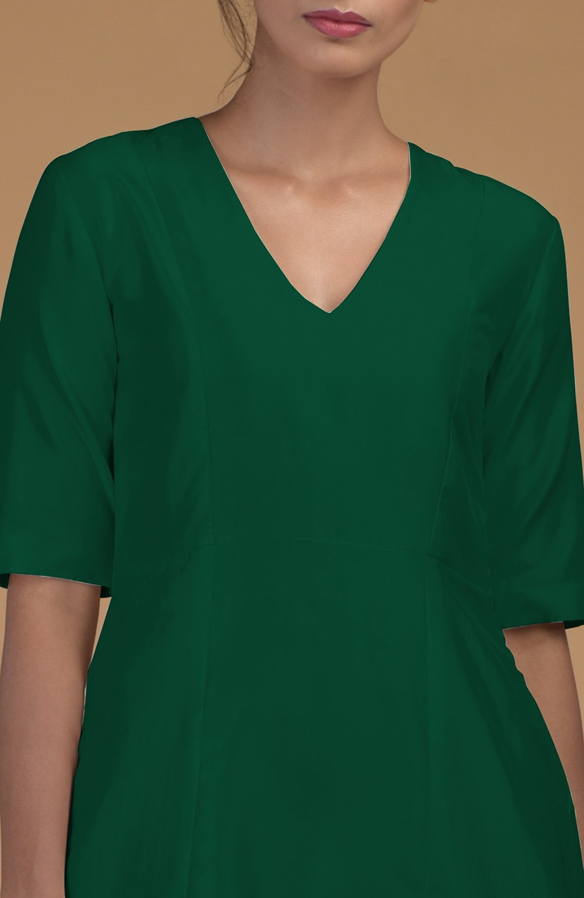 An emerald green pure Matka silk V-neck kali kurta with half sleeves.