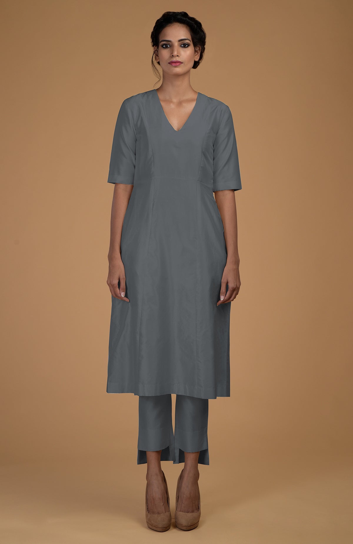 A woman models a grey pure Matka silk V-neck kali kurta set with slim pants.