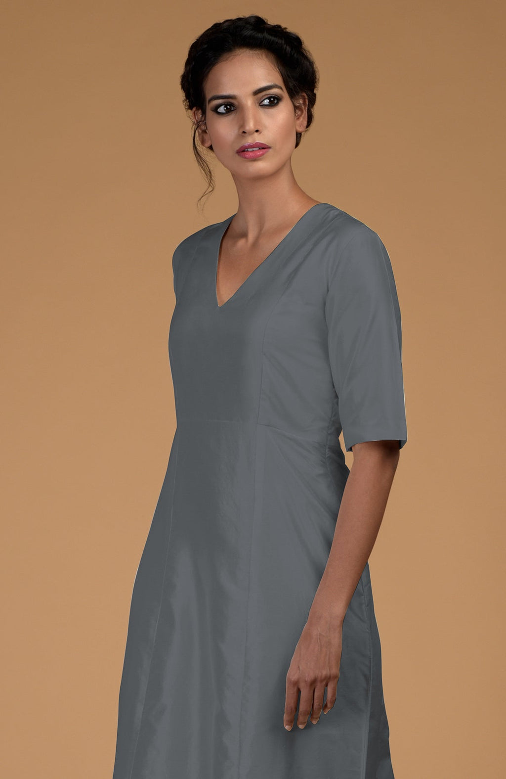 A woman models a grey pure Matka silk V-neck kali kurta with half sleeves.