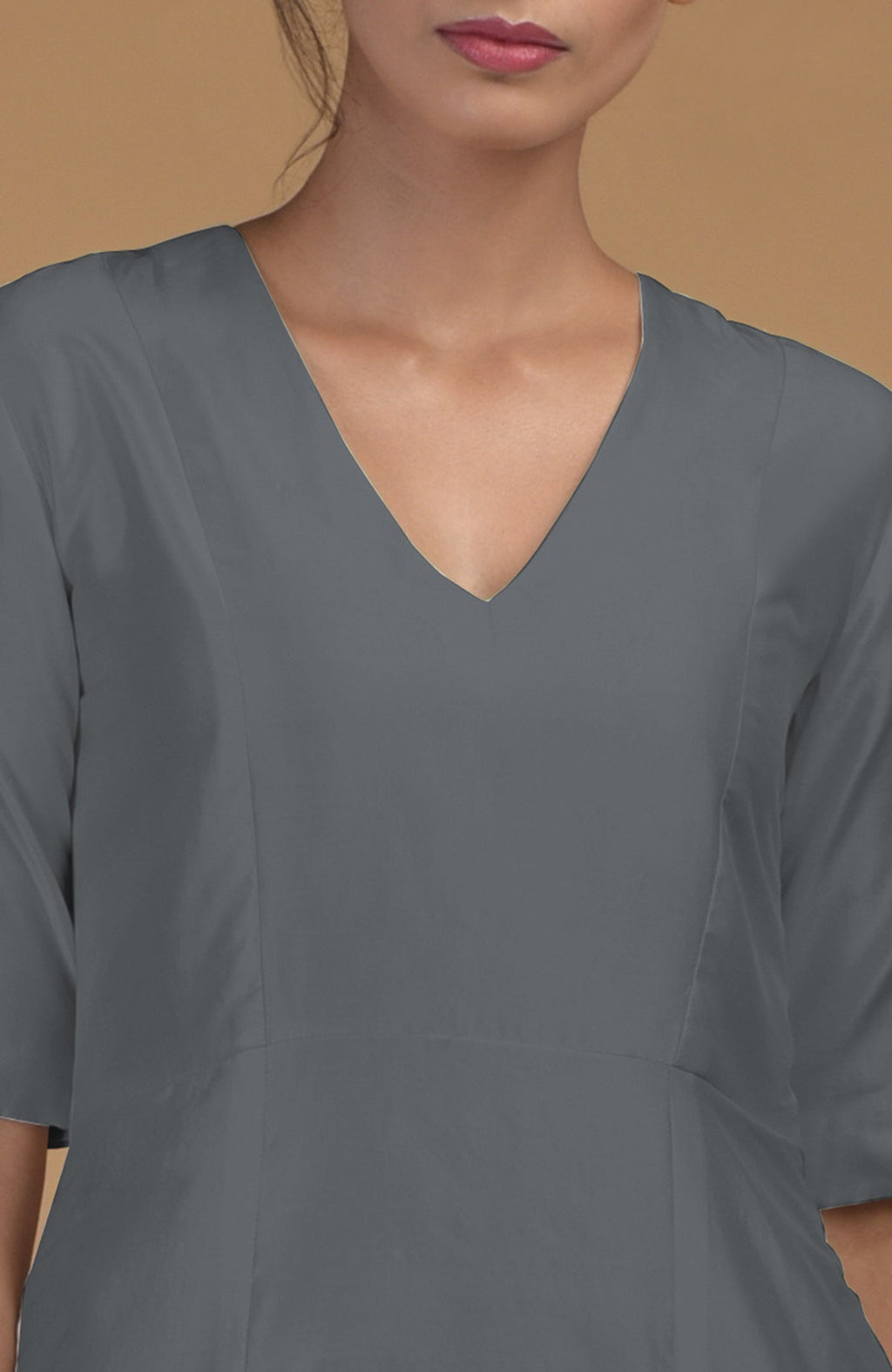 A woman wears a grey pure Matka silk V-neck kali kurta.