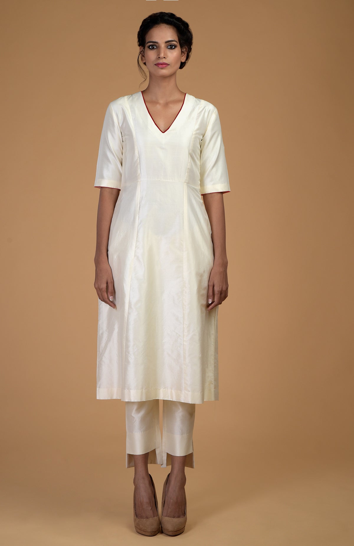 An ivory pure Matka silk V-neck kali kurta set with slim fit asymmetric hem pants.