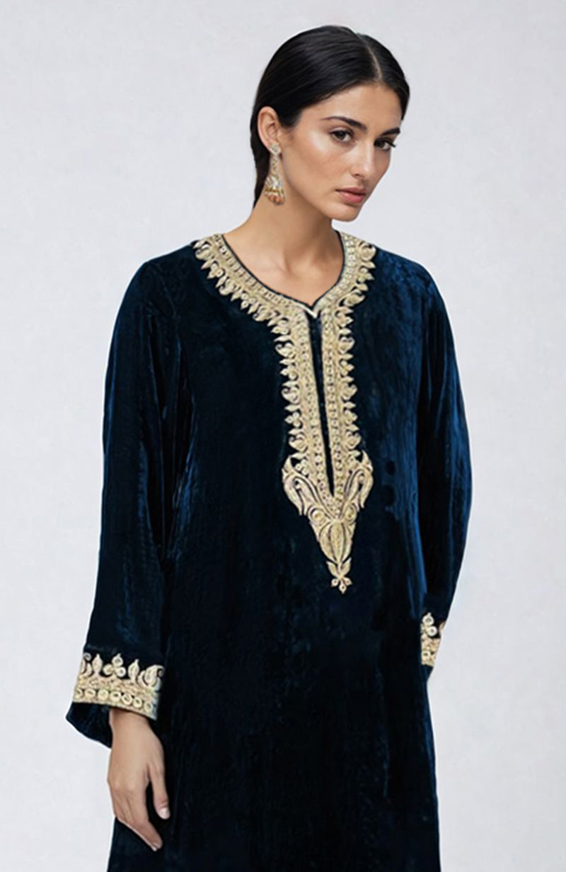 A woman models a midnight blue velvet kurta with gold Kashmiri tilla dozi embroidery.