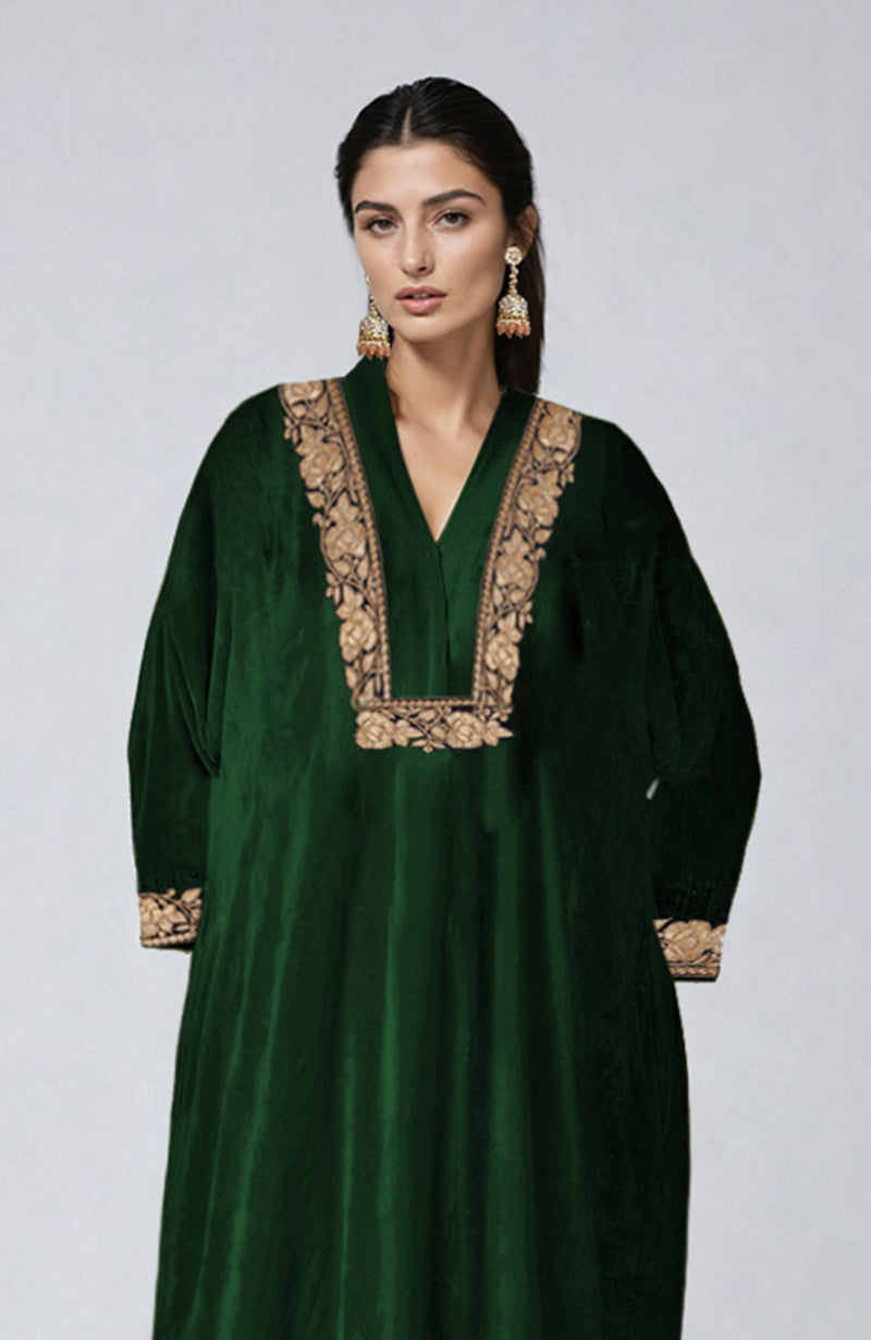 Emerald green velvet kurta with Kashmiri tilla dozi embroidery on the neckline and sleeves.