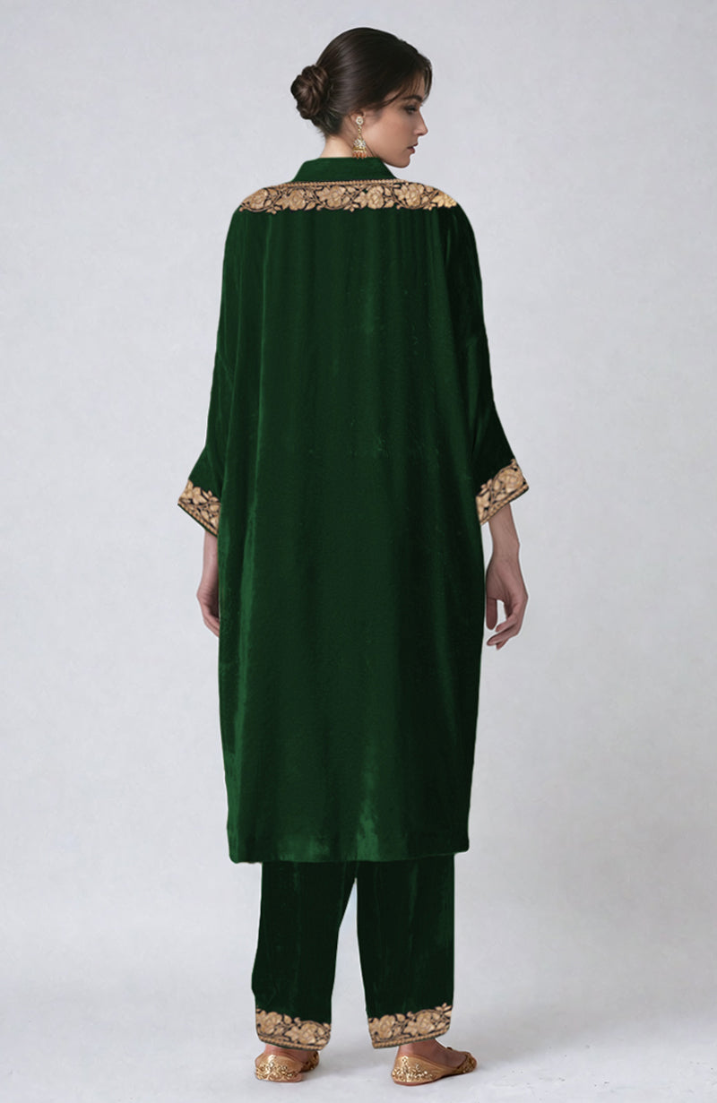 Emerald green velvet kurta set with Kashmiri tilla dozi embroidery on the neckline, sleeves, and pants.