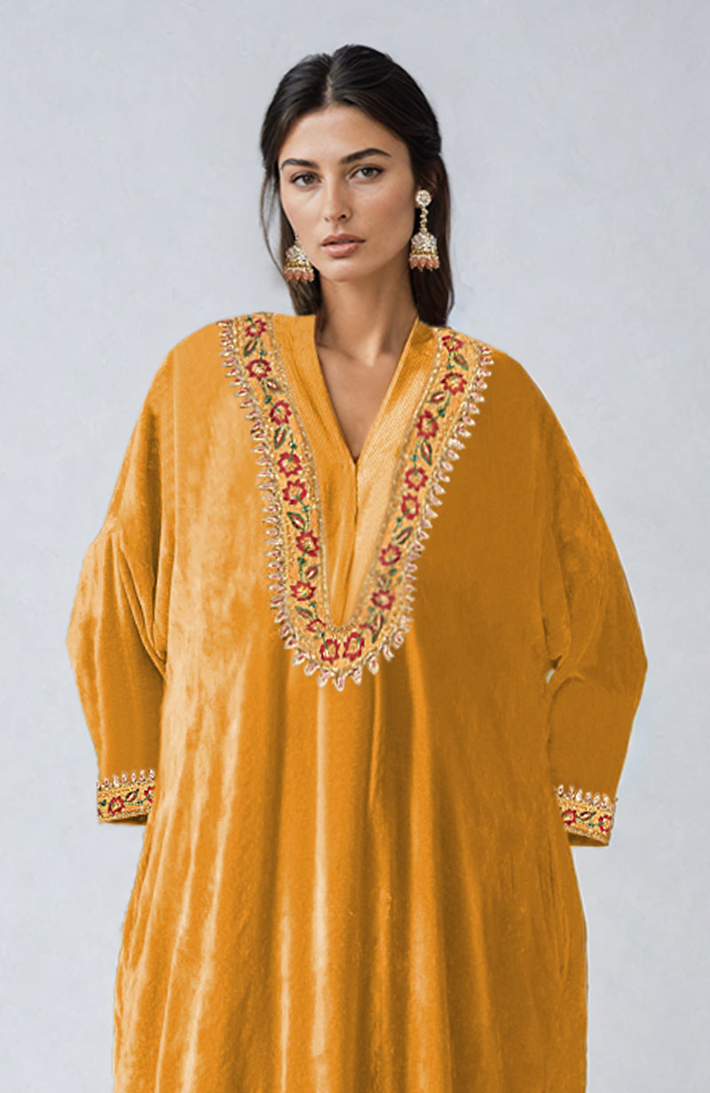 Mustard velvet kurta with colorful floral embroidery on the neckline and sleeves.