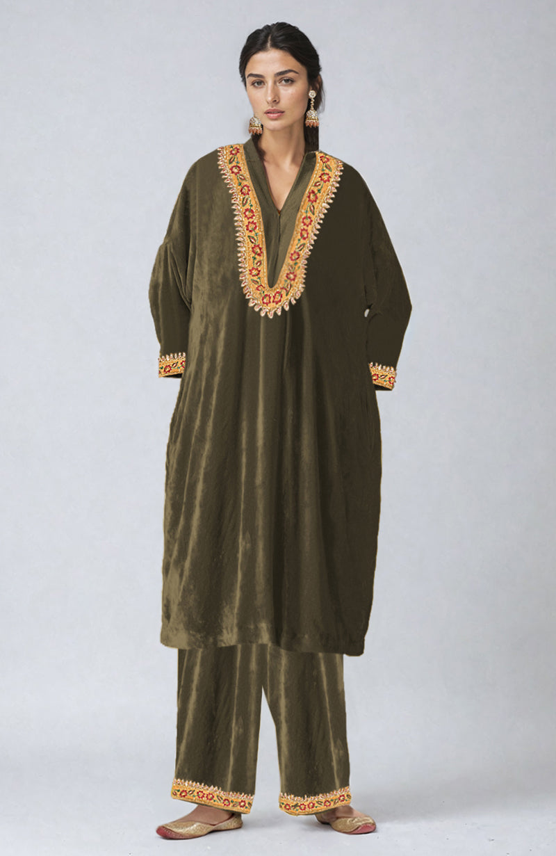 Mustard velvet kurta set with colorful floral embroidery on the neckline, sleeves, and pants.