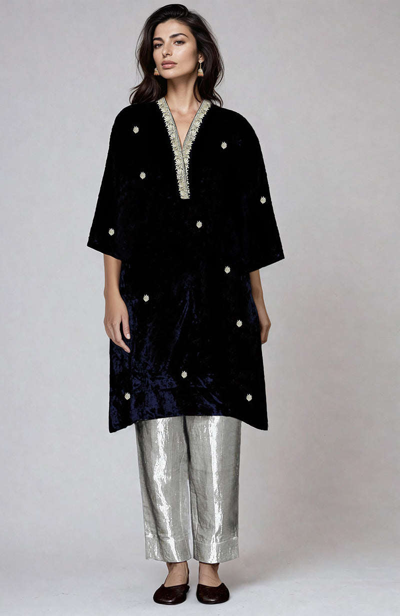 Midnight blue velvet kurta with silver embroidery and silver tissue pants.