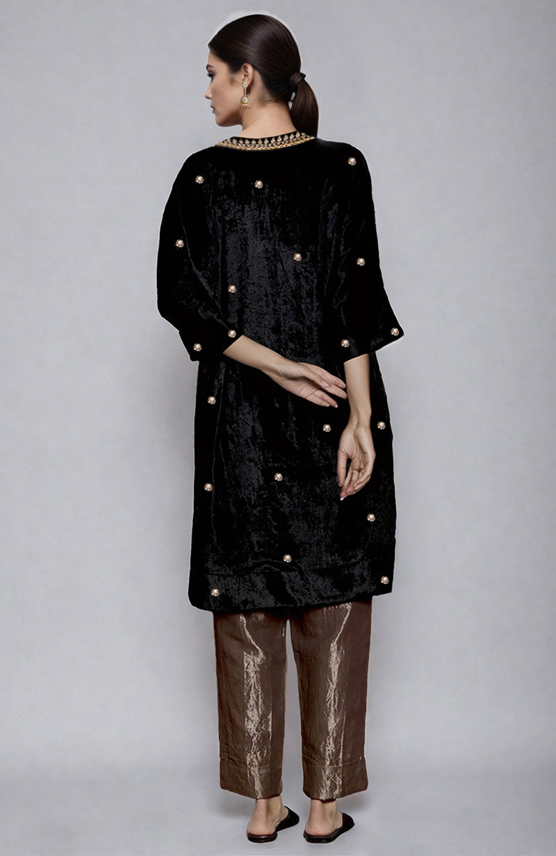 Black velvet kurta with gold embroidery and gold tissue pants.
