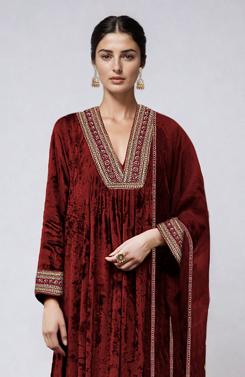 Maroon velvet kurta set with gold zardozi embroidery on the neckline and sleeves.
