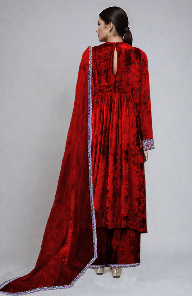 Red velvet kurta set with intricate embroidery.