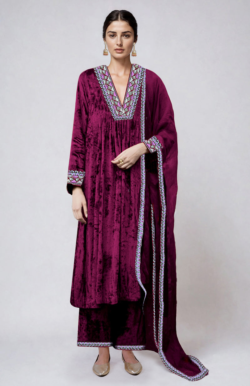 Bright rose velvet kurta set with intricate resham and zardozi embroidery.