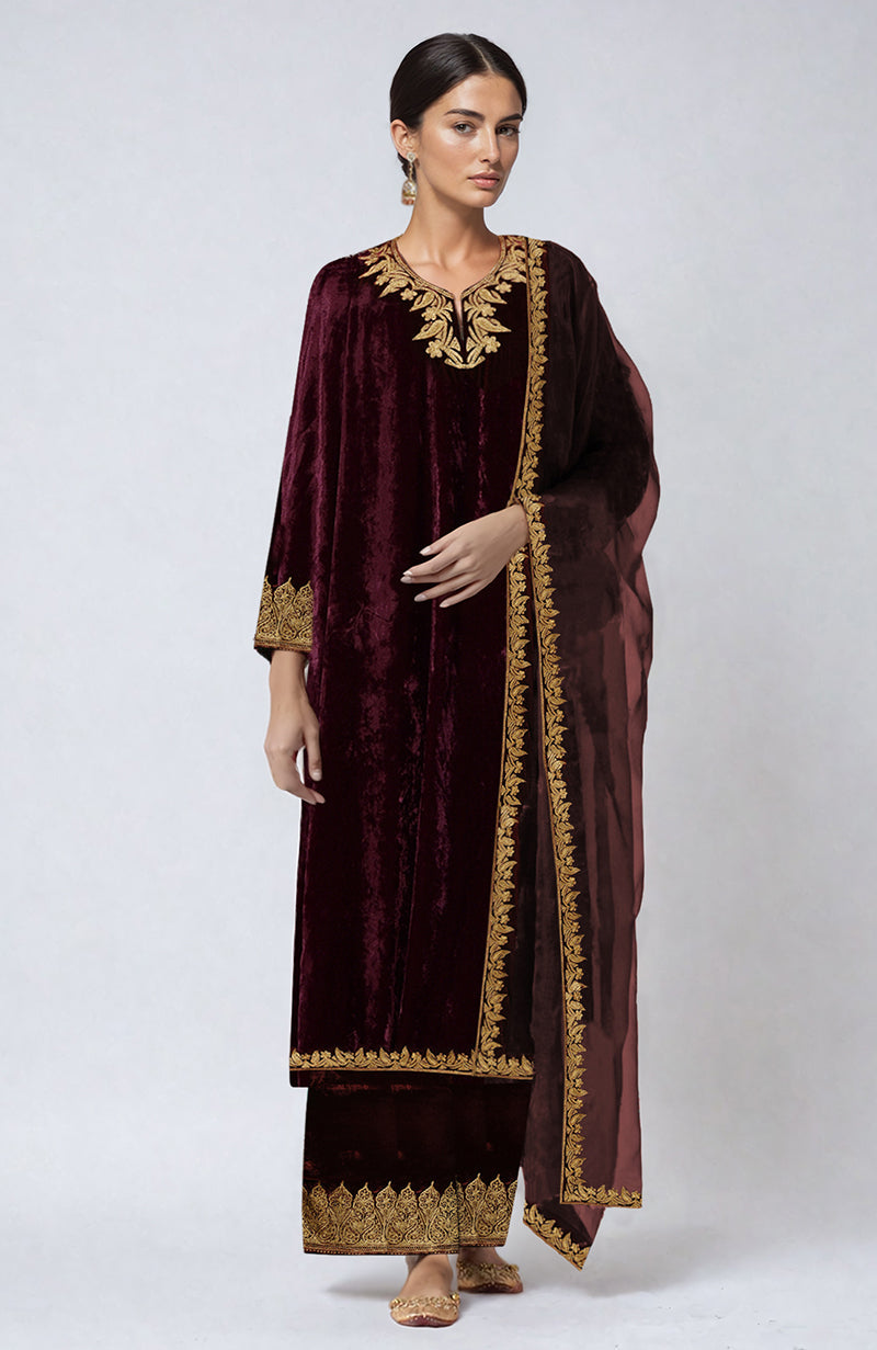 A woman models a maroon Kashmiri Tilla Aari embroidered palazzo set.