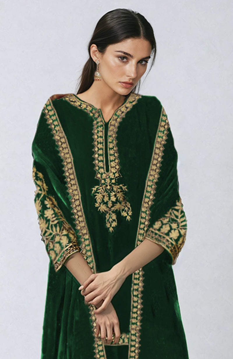 Emerald green velvet sharara set with intricate gold tilla embroidery.