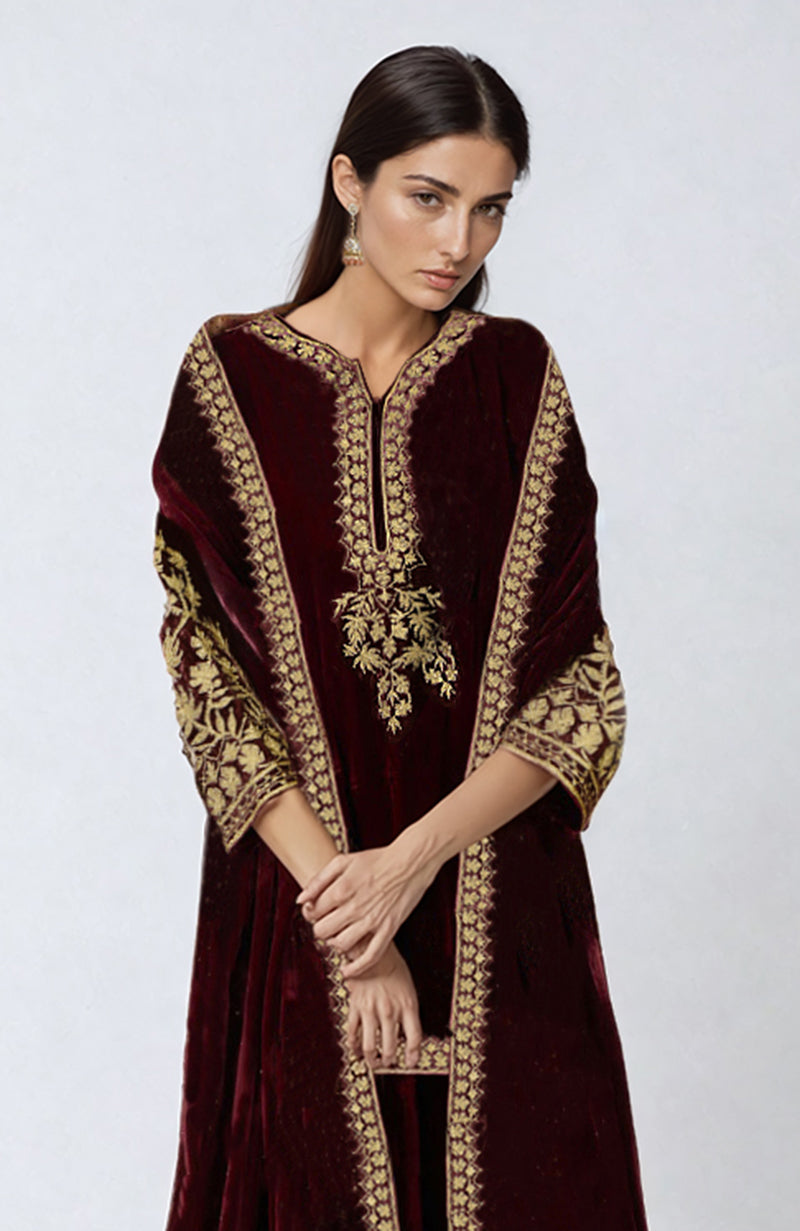 Maroon velvet Kashmiri Tilla embroidered sharara set with gold embroidery.