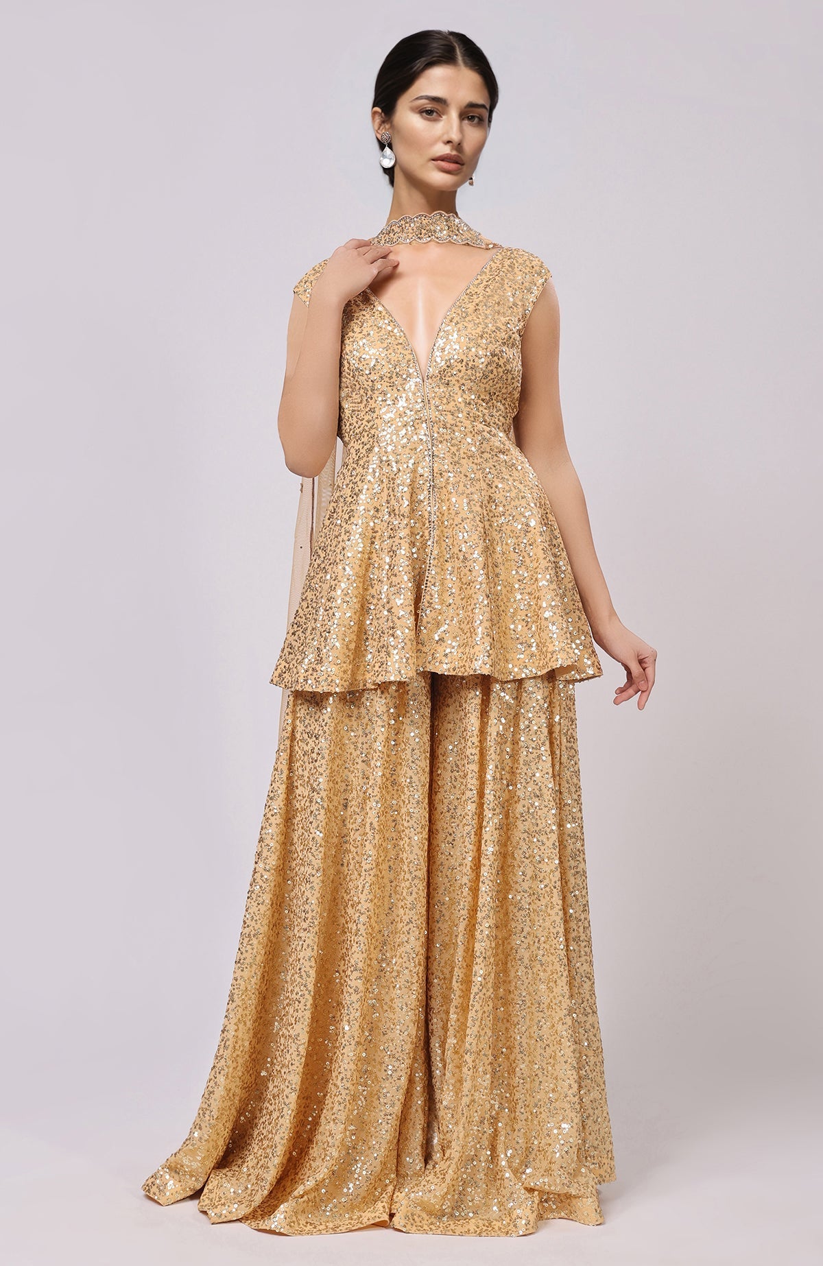 Gold sequined peplum top with deep V-neck, flared sharara pants, and embellished dupatta.